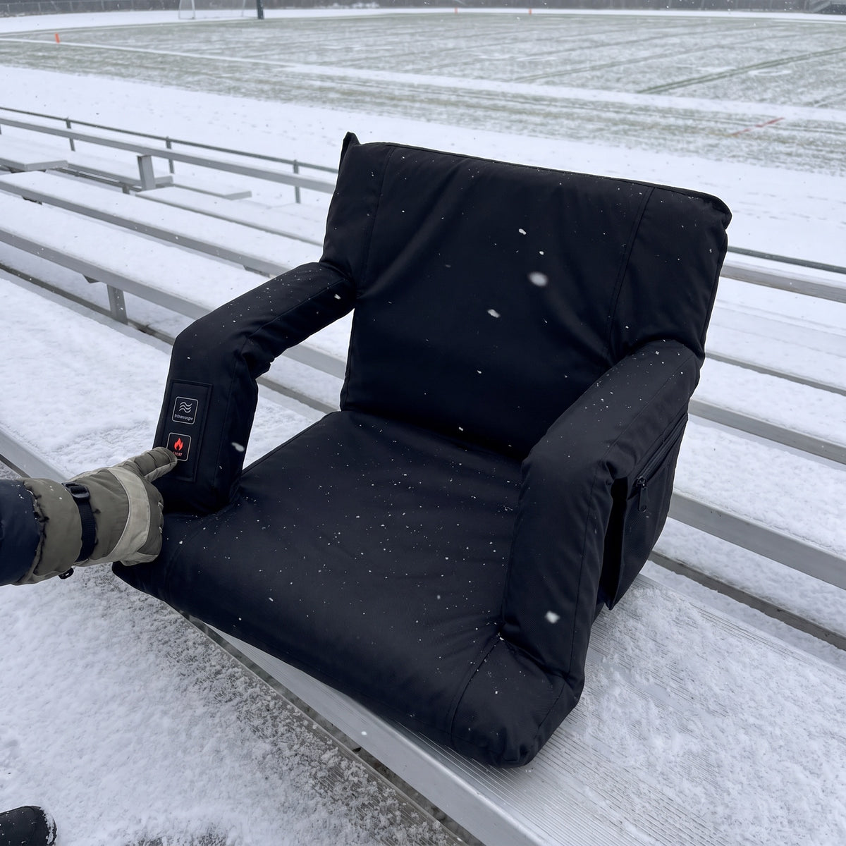 Pressing the Heat button on a snowy bleacher
